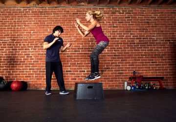 a trainer and a client working out