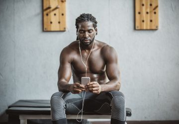 a fit man listening to music