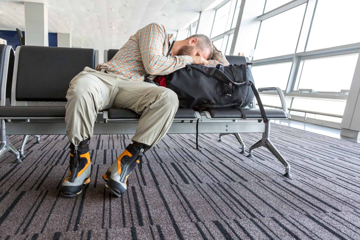 a man sleeping in an airport