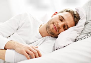 Picture showing young man sleeping in bed