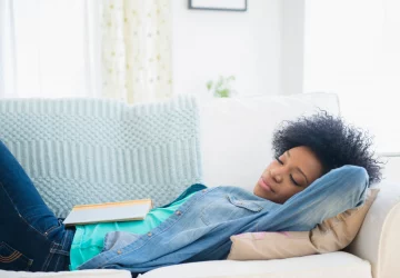 a woman taking a nap on the couch