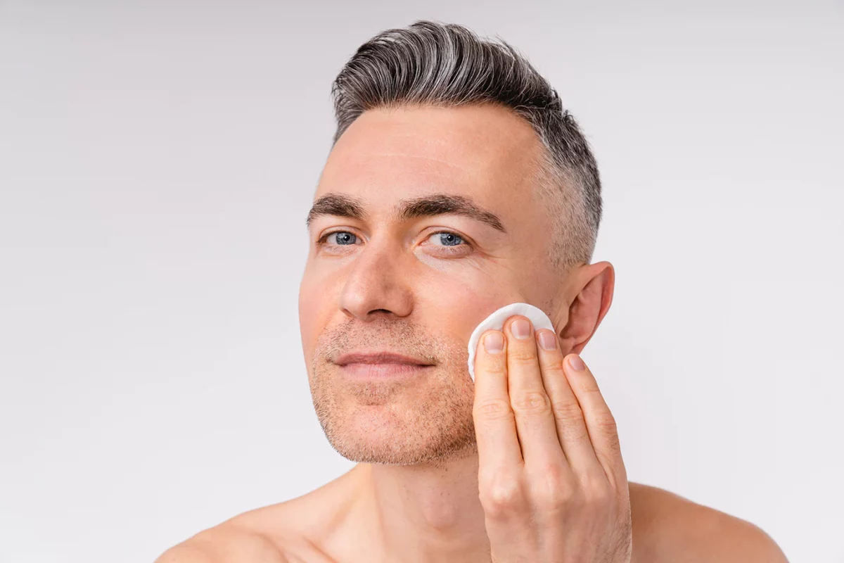 a older man applying skin care products