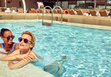 a pair of women wearing sunglasses in a pool